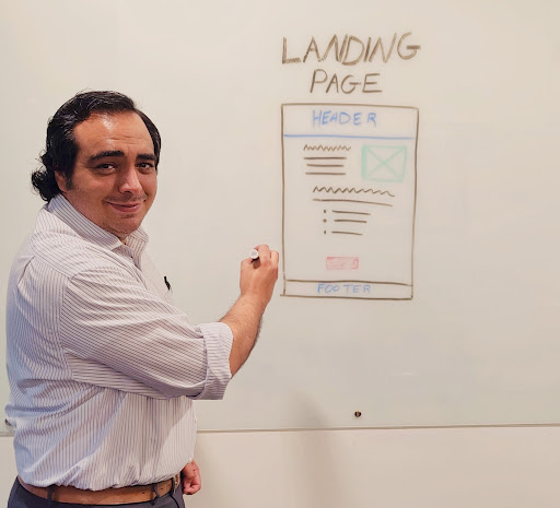 As part of a marketing mentorship program, KWSM Digital Marketing Specialist David Jones maps out a landing page wireframe on a whiteboard before launching a small business marketing campaign.