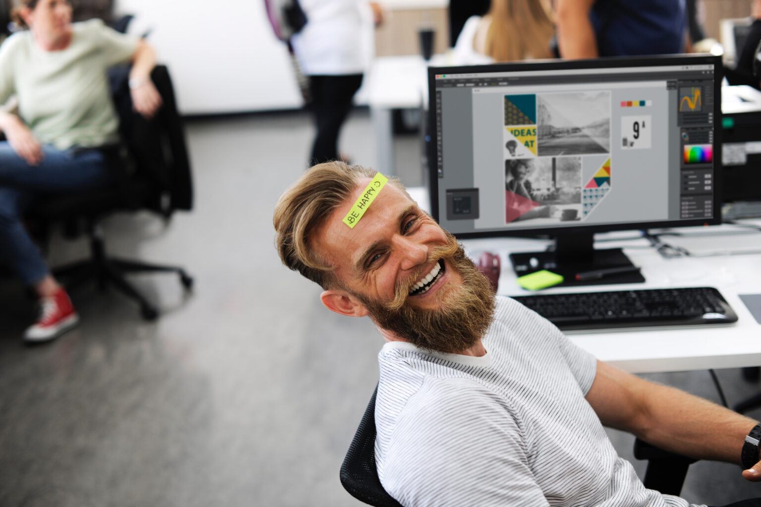 Bearded fellow having fun at his desk