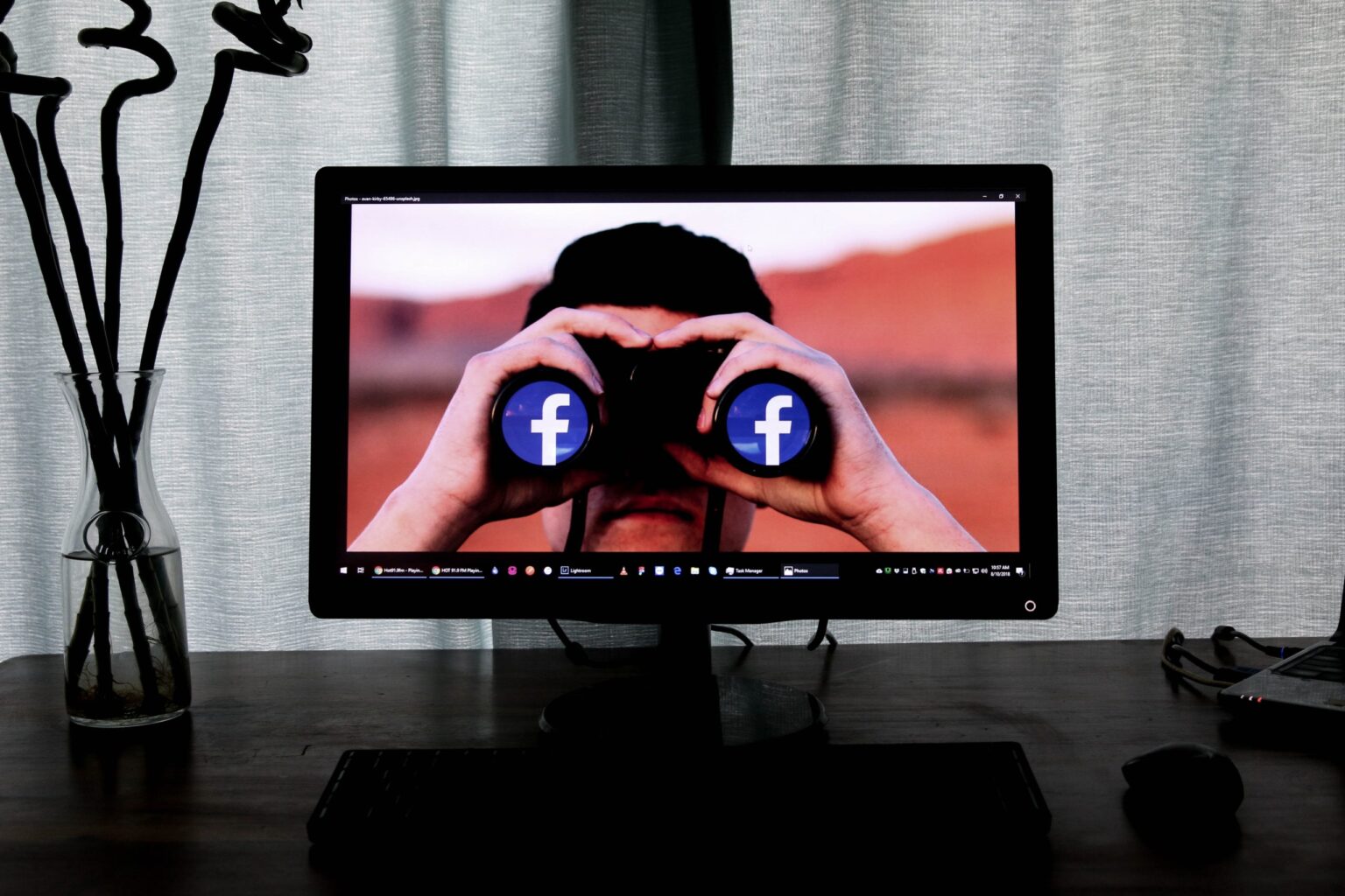 man with binoculars on desktop screen