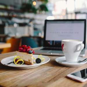 Misused Facebook Insights | Katie Wagner Social Media | Coffee shop and cafe workspace with MacBook being used to work along with a plate of pie and a cup of coffee