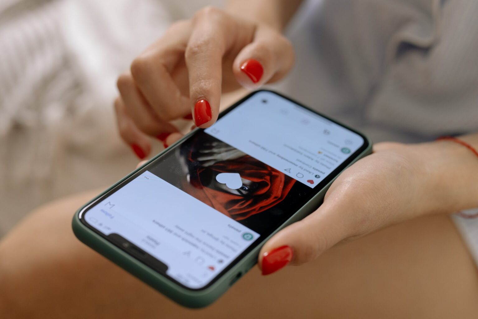 A woman likes a photo on Instagram on her iPhone.